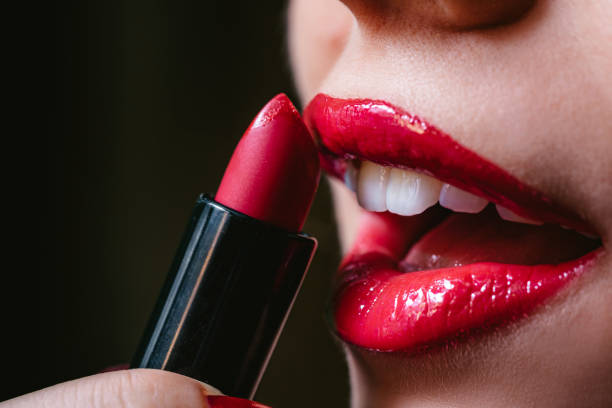 istock Woman applying lipstick 1312332093