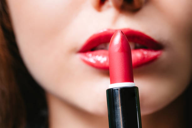 istock Woman applying lipstick 1312332120