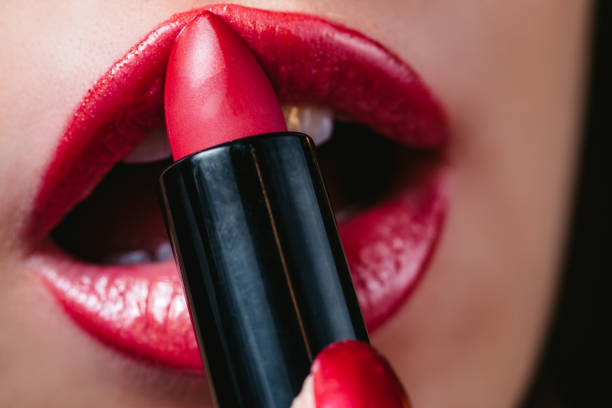 istock Woman applying lipstick 1312332134