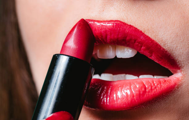 istock Woman applying lipstick 1312332653