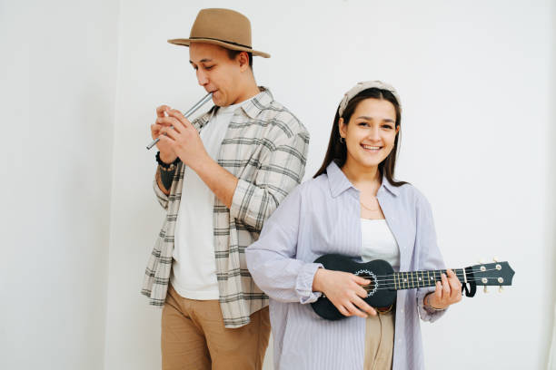 istock Cheerful man and woman playing thier instruments inside a room. 1312335110
