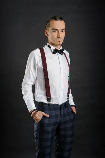 istock Young handsome boy in white shirt with tie and glases, hands in pockets 1312335765