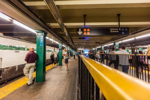 New York City, United States - August 26, 2017: Subway station, with people on a platform waiting for a train.