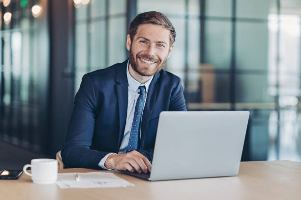 istock Cheerful young businessman working in the office 1312339221