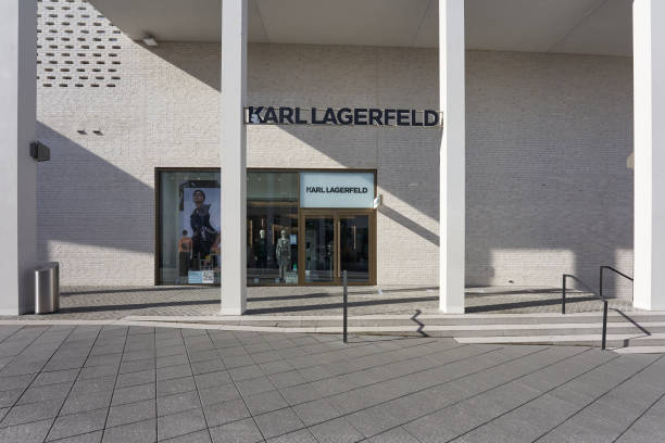 Karl Lagerfeld Outlet store. Bright exterior facade with angular columns. Hard shade. Front view. Wide angle. Metzingen, Germany - March 20, 2021: Karl Lagerfeld Outlet store. Bright exterior facade with angular columns. Hard shade. Front view. Wide angle. karl lagerfeld stock pictures, royalty-free photos & images