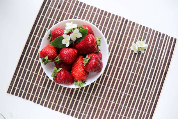 istock fresh ripe strawberries on a white dish 1312342169