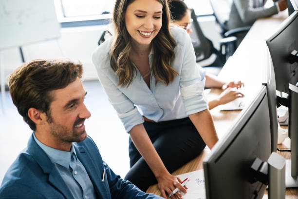 istock Happy business people having fun and chatting at workplace office 1312345463