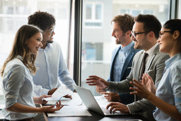 istock Happy business people having fun and chatting at workplace office 1312345501