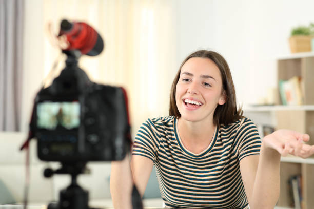 Happy influencer recording video talking at camera