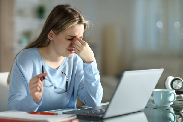 istock Student suffering eyestrain learning in the night with a laptop 1312345946