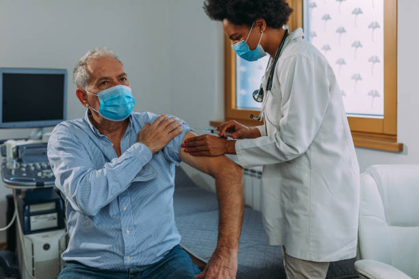 istock Senior man getting vaccinated at hospital 1312345988