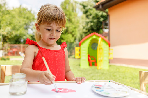 Girl painting with watercolors