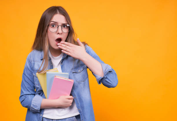 istock Shocked funny student with books in glasses. 1312348127