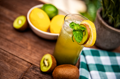This is a close-up photograph of a Kiwi Lemon fresh fruit drink for the summer time with mint
