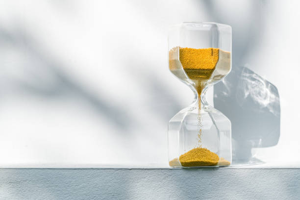 Golden Hourglass at outdoor with long shadow stock photo