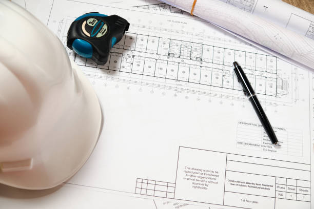 istock Hardhat, blueprint, measuring tape and pen 1312350596