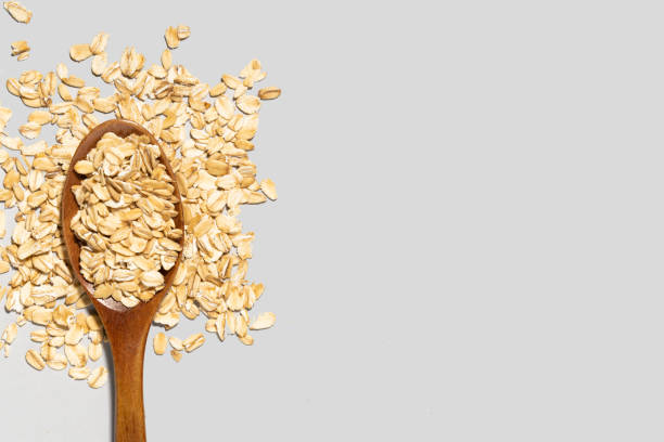 istock wooden spoon and oatmeal on gray background 1312352981