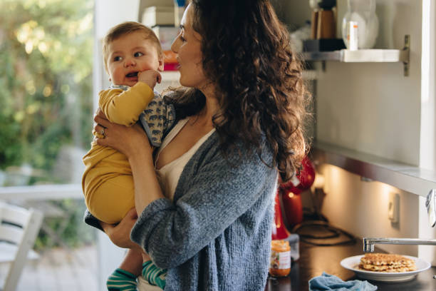 istock Mom in kitchen with baby 1312353496