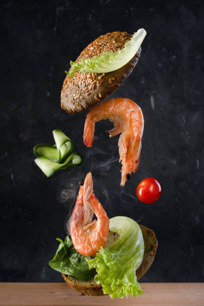 istock the flying burger with shrimps on black background 1312354156