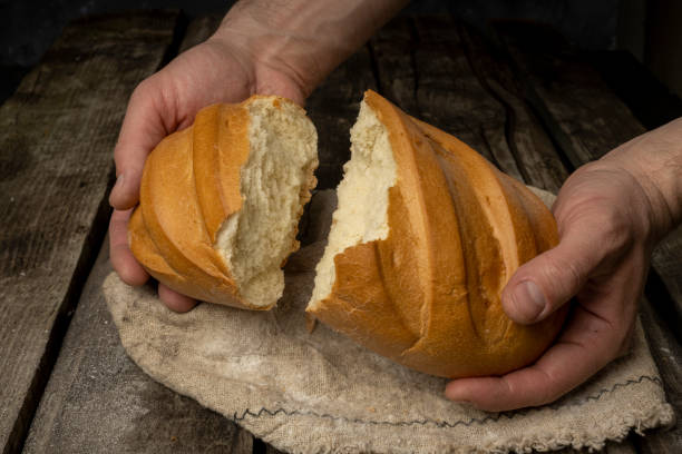istock Freshly backed farmhouse bread on an old rustic wooden board. Retro style. 1312354447