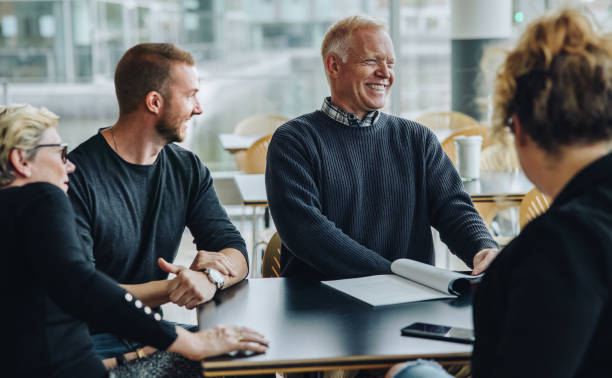 istock Smiling senior businessman having meeting with team 1312354550