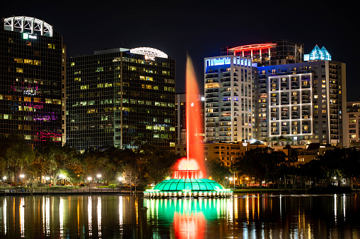 Florida, USA - Feb. 10, 2021: Scenic night view of colorful fountain at Lake Eola Park nobody