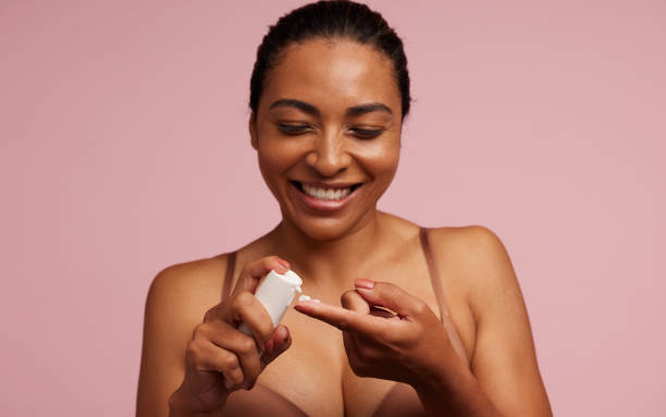 istock Woman using skincare product 1312355905