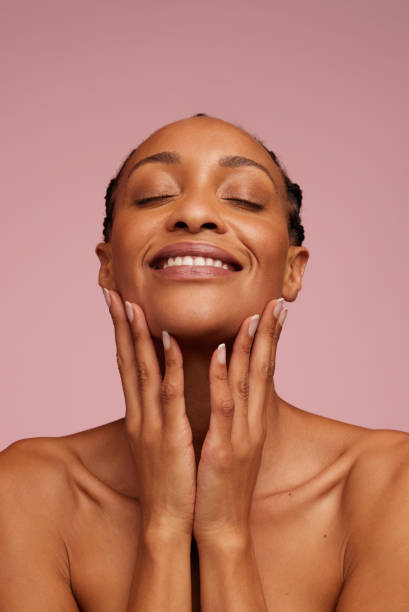istock Beautiful woman touching her face and smiling 1312356543