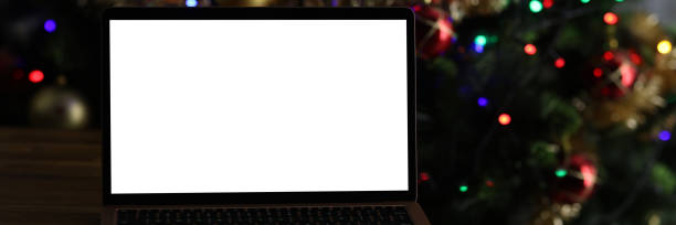 istock Open laptop standing on table near New Year tree 1312356918