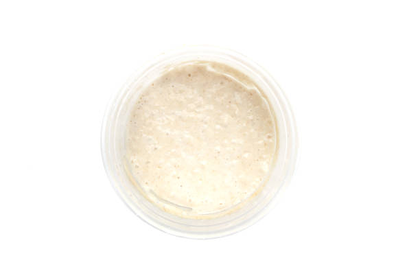 Top view of sourdough starter isolated on white background. Top view of sourdough starter in the jar isolated on white background. yeast starter stock pictures, royalty-free photos & images