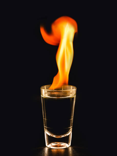 istock Burning alcoholic drinks with big flame, on black background with copy space 1312358939