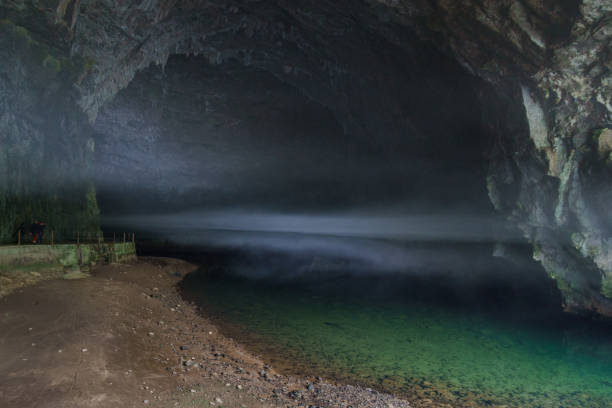 istock underground river flows out of cave with fog 1312361793