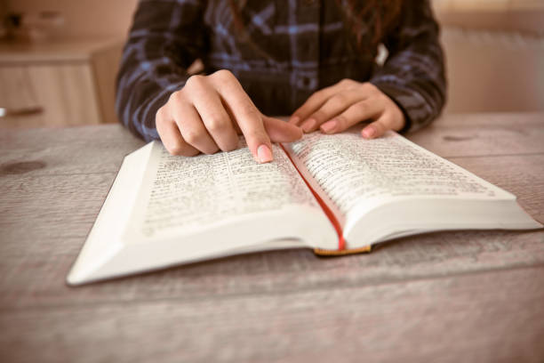 istock woman reading Holy Bible 1312362108