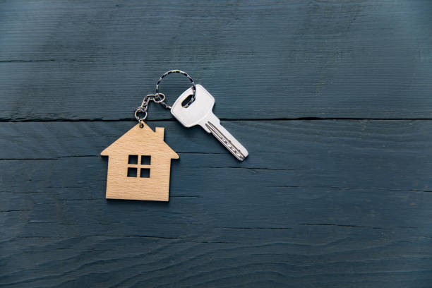 istock Key with trinket in shape of house 1312362126