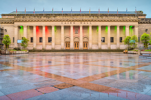 Caird Hall, concert hall, in downtown Dundee Scotland, illuminated at dusk.