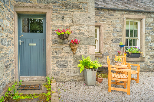 Front yard patio of a stone house in Blair Atholl, Perthshire, Scotland on a cloudy day.