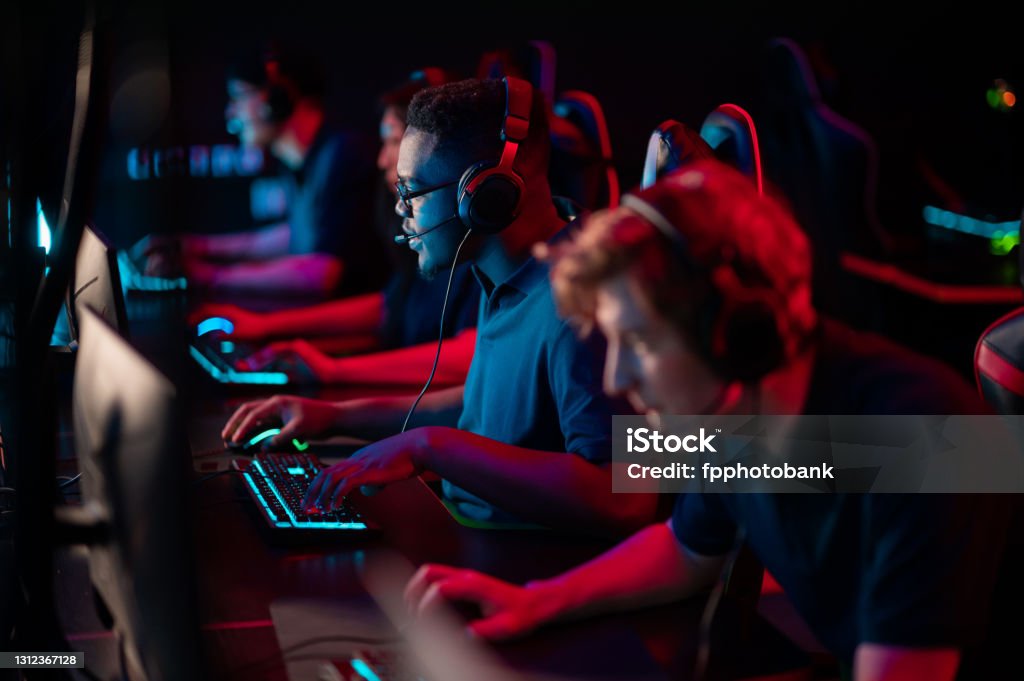 Professional esports players at an online game tournament. The cyber team plays computers and trains Professional esports players at an online game tournament. The cyber team plays computers and trains. eSports Stock Photo