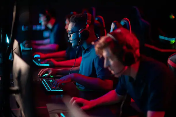 Photo of Professional esports players at an online game tournament. The cyber team plays computers and trains