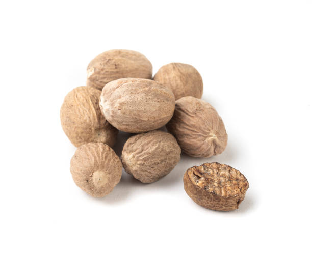 istock Group of nutmegs isolated over white background 1312372540