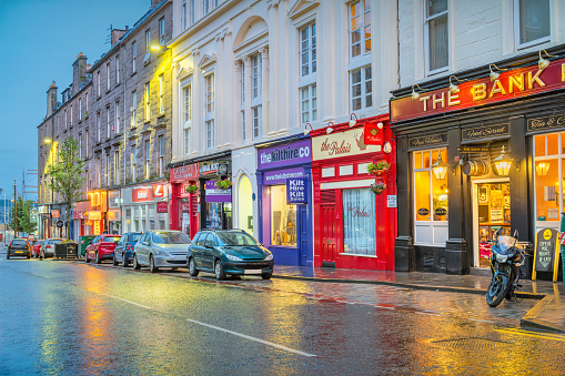 Colorful businesses in downtown Dundee Scotland in the evening
