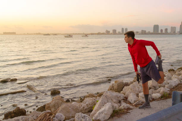 istock Young athletic man running, doing Exercises and training for marathon outdoors at Miami Beach, Florida, USA 1312374424