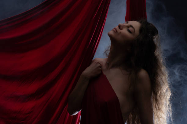 istock Gorgeous nude woman with red color silk. 1312375404
