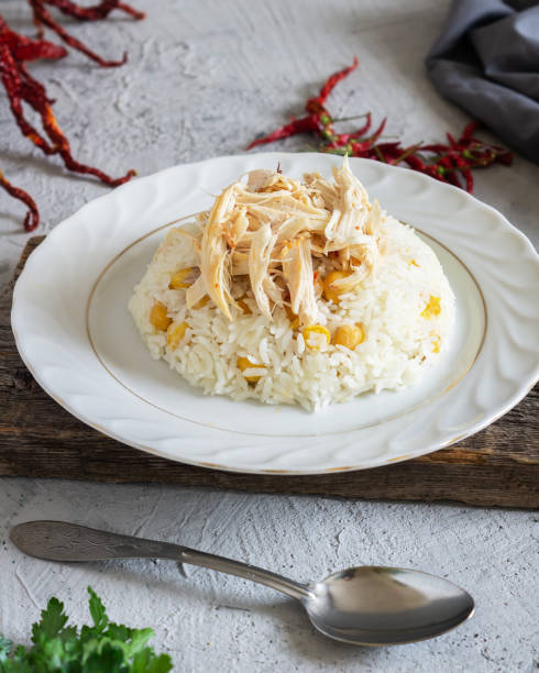 istock Traditional turkish food, chicken pilaf, rice with chickpeas in plate on rustic background 1312376769
