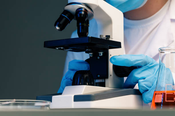 istock Close up photo of woman scientist working with microscope 1312376876
