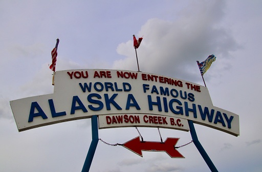 The Alaska Highway sign in Dawson Creek, British Columbia, points toward the start of the 1390 mile road built during WW2 that joins Canada and Alaska.