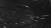 Black wrinkled plastic wrap. Glossy cloth background. 3D render.