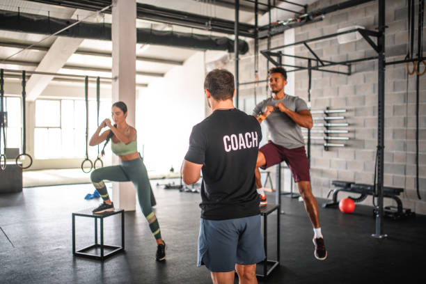 istock Coach Watching Athletes Do Box Jump Repetitions in Gym 1312385643