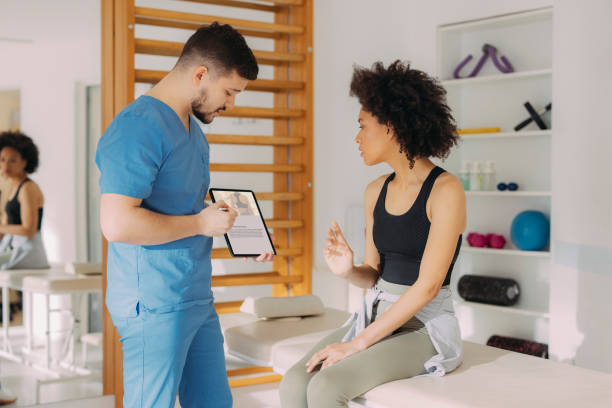 istock Physical Therapist and Young Woman Having a Conversation While the Therapist is Explaining Something on a Tablet 1312385953