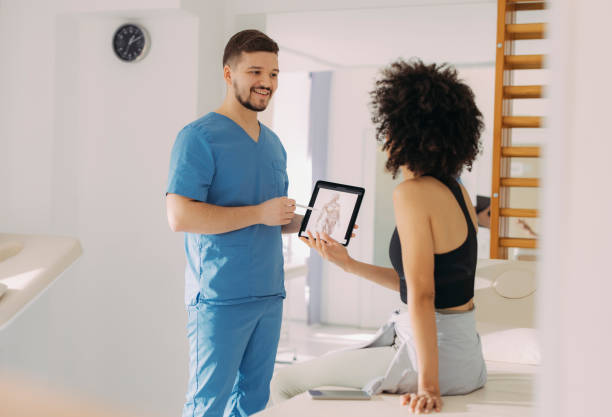 istock Physical Therapist and Young Woman Having a Conversation While the Therapist is Explaining Something on a Tablet 1312385960