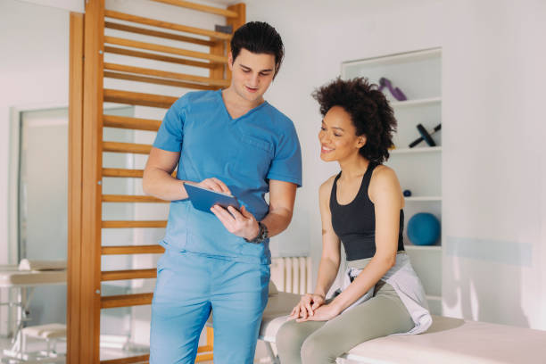 istock Physical Therapist and Young Woman Having a Conversation While the Therapist is Explaining Something on a Tablet 1312385963